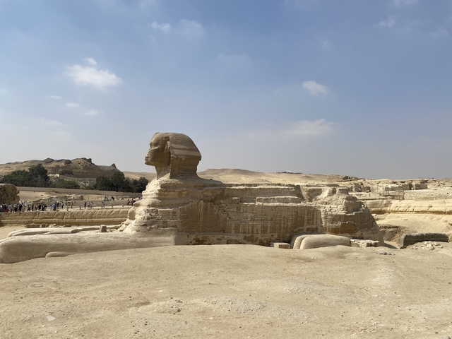 The Sphinx statue with arid landscape in the background.