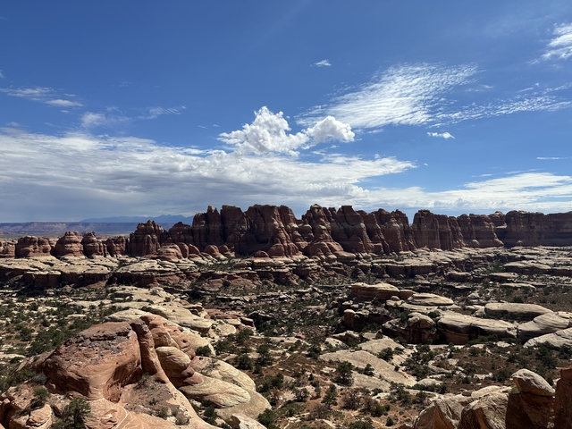       Red rock formations under a bright blue sky.
  