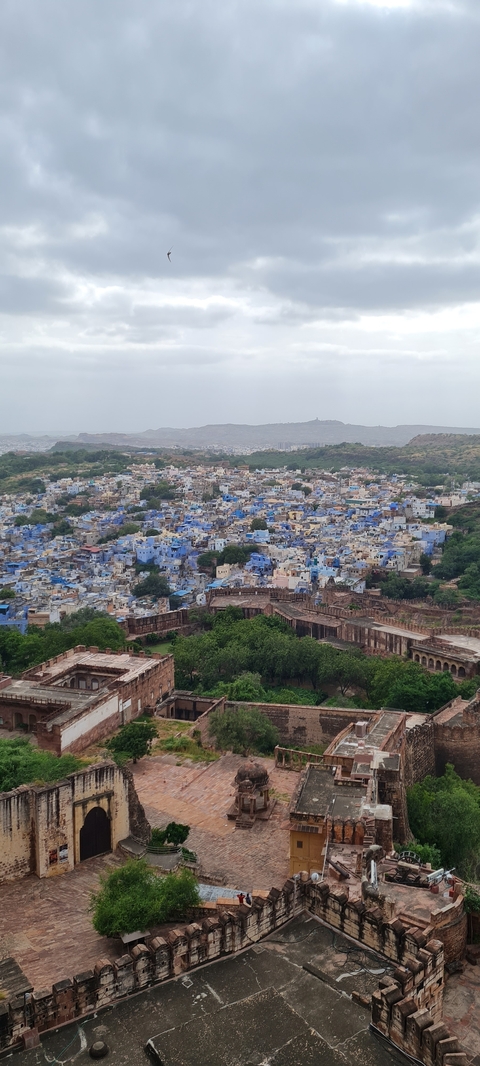       Aerial view of a historic city painted in blue.
  