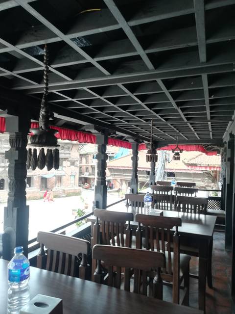       View from an ornate patio overlooking a historic neighborhood.
  
