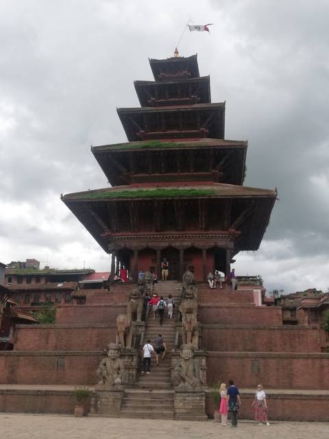       Historic temple with intricate architecture under cloudy skies.
  