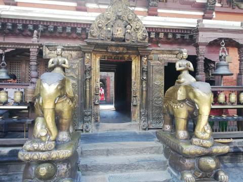      Intricate temple entrance with golden elephants.
  