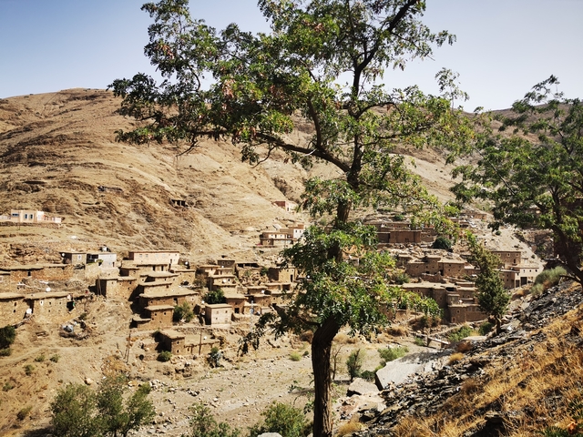       A village nestled in a rugged mountain landscape
  
