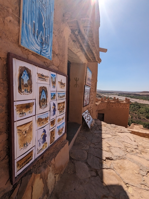       Art pieces displayed in an outdoor setting with a desert view.
  