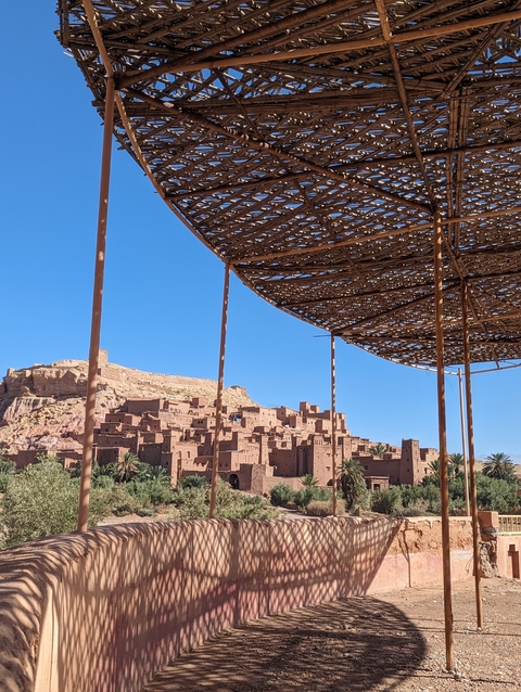       Rooftop view of Ait Benhaddou with a woven canopy.
  