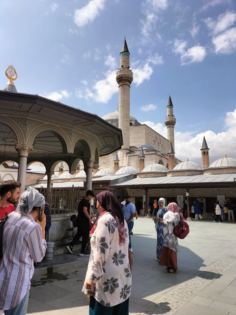       Visiting people at a bustling mosque complex.
  