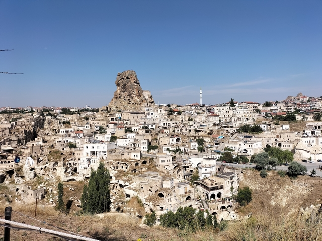 Wide view of a town with a distinct rocky formation.