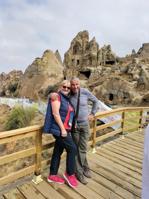 Couple posing in a rocky landscape with unique formations.