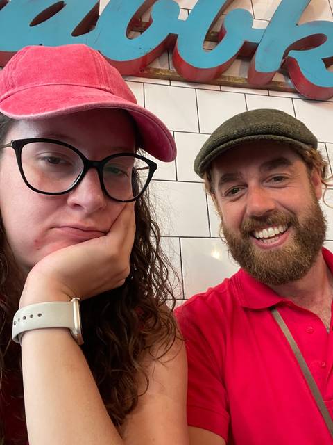 Two people sitting at a cafe.
