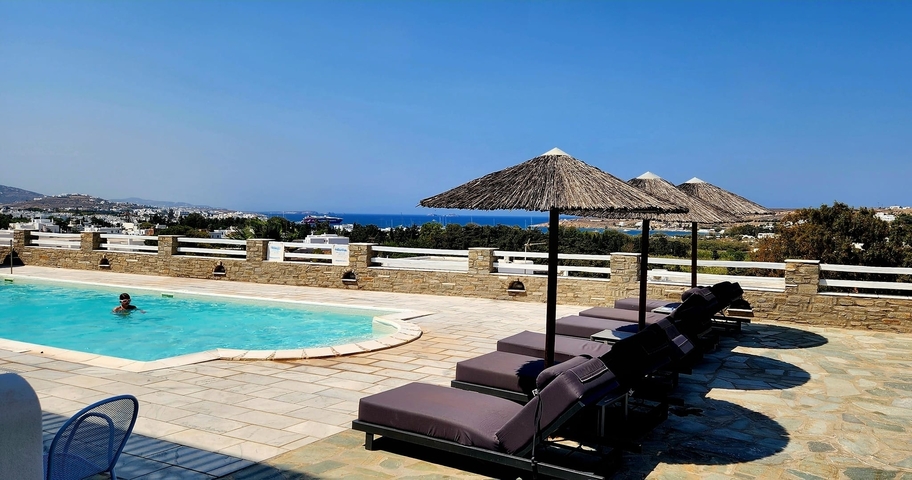 Swimming pool with a view of the sea in the distance.