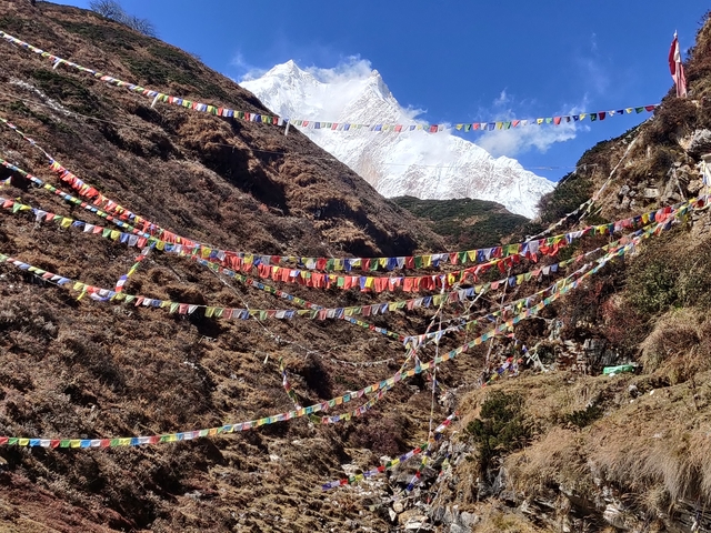 Mountain landscape with colorful prayer flags.