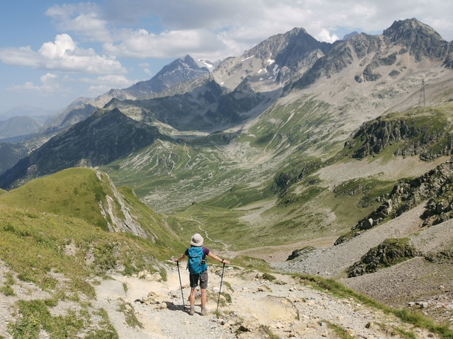 Person hiking in a mountainous landscape with expansive views