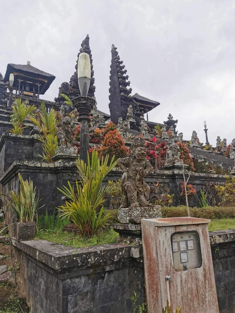Ornate temple structure with statues and tropical plants