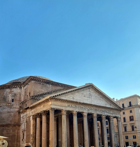 Historic building with architectural details under a clear blue sky.