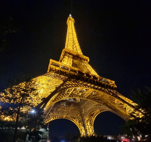 The Eiffel Tower illuminated at night.