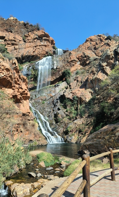 A waterfall in a rocky canyon area.