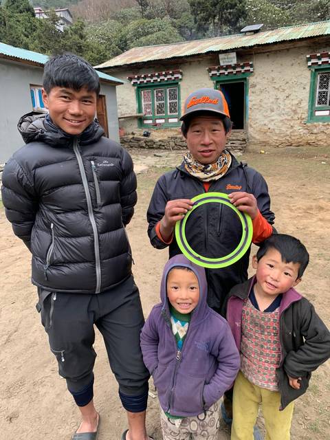 A family posing with a frisbee.