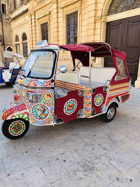       Colorful, traditional vehicle with intricate designs.
  