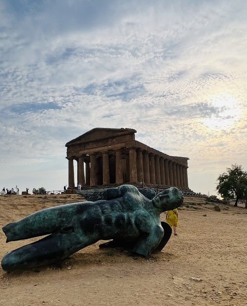 Ancient temple ruins with sculpture of a reclining figure.