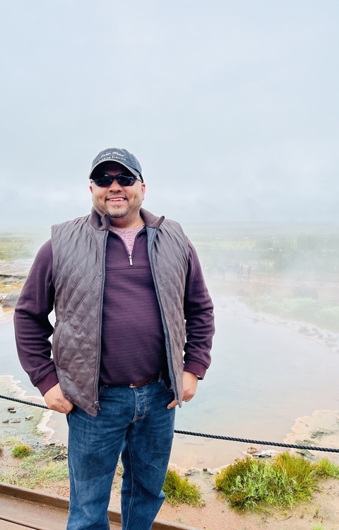       Man standing in a misty outdoor environment.
  