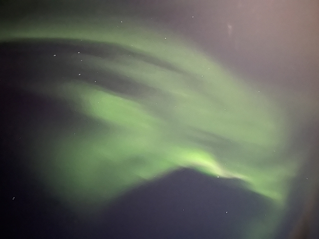       Aurora Borealis visible in a dark night sky.
  