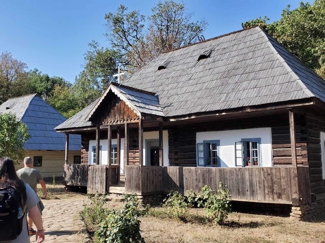       Traditional wooden houses with people walking.
  