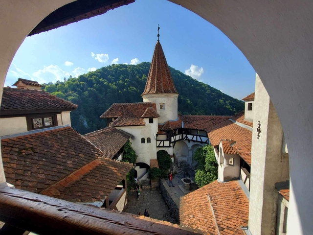       Historic castle viewed from an archway.
  