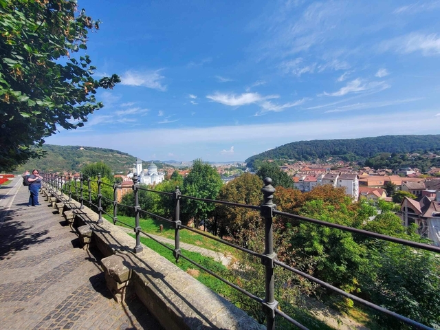       View of city with distant hills in the background.
  