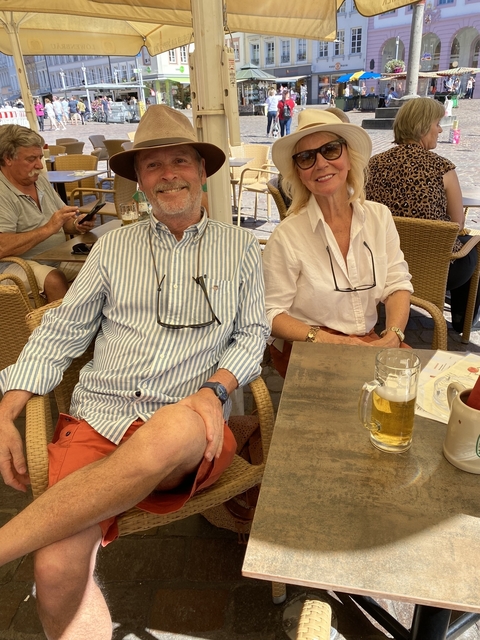 Two people sitting outdoors at a café.