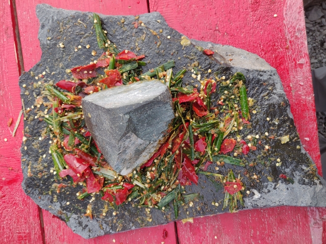 Spices and herbs on a stone slab.