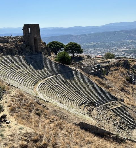       Ancient amphitheater on a hillside.
  