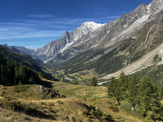 Scenic valley surrounded by towering mountains.