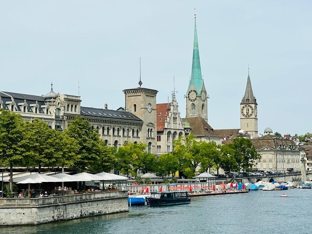 Cityscape with historical buildings and river frontage.