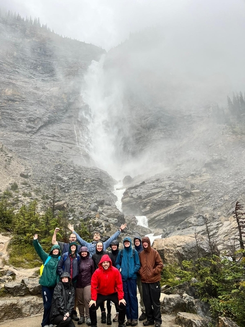 Large waterfall cascading down rocky cliffs with mist.