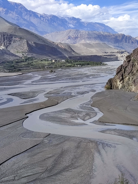       Braided river with mountains in the distance.
  