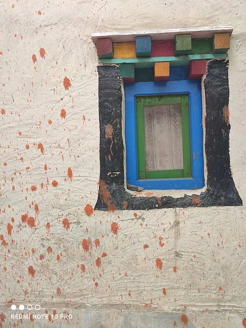       Window in a rustic painted wall.
  