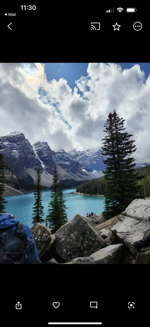       Crystal clear lake with snow-covered mountain backdrop.
  