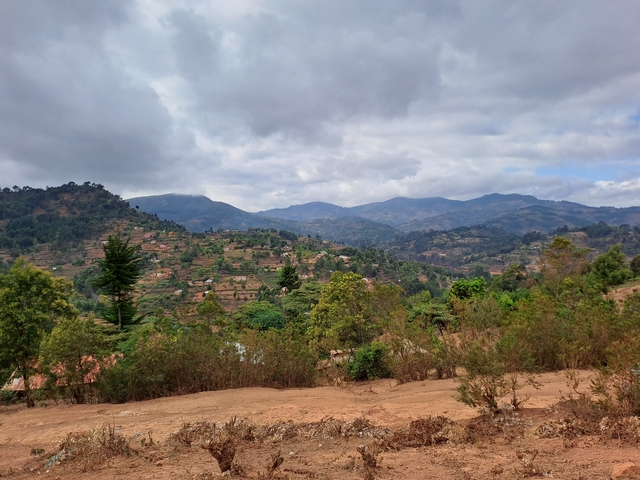 Hilly landscape with villages and dense vegetation.