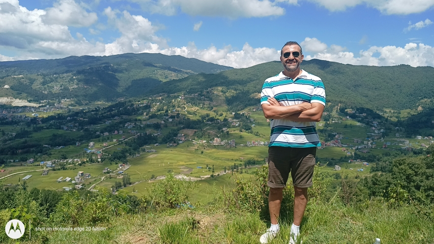       Person with picturesque landscape in the background.
  