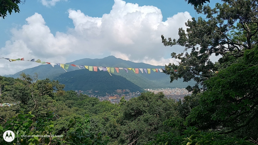       Scenic landscape view of hills with prayer flags.
  