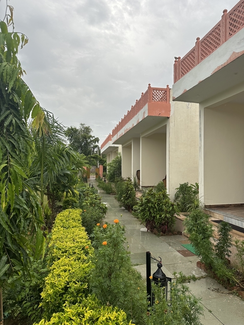       Exterior view of a building with a garden path.
  