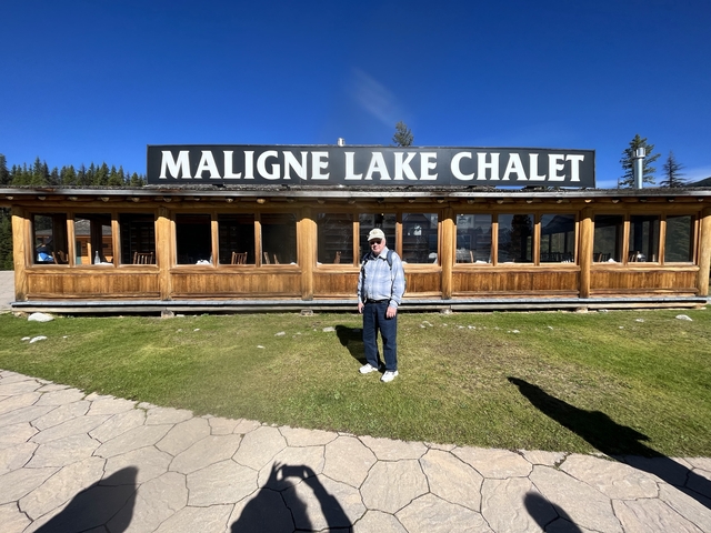 A person standing outside Maligne Lake Chalet.