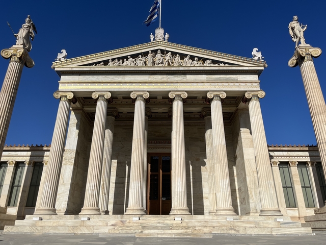       Facade of a neoclassical building with columns and statues
  