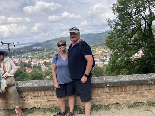 Couple posing with a scenic view of a town