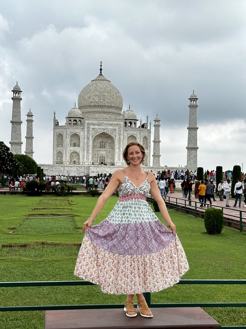 A woman posing in front of the Taj Mahal.