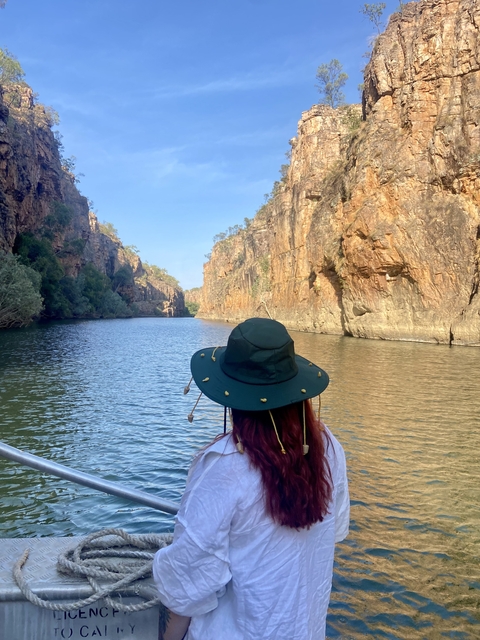 Person on a boat in a river canyon.
