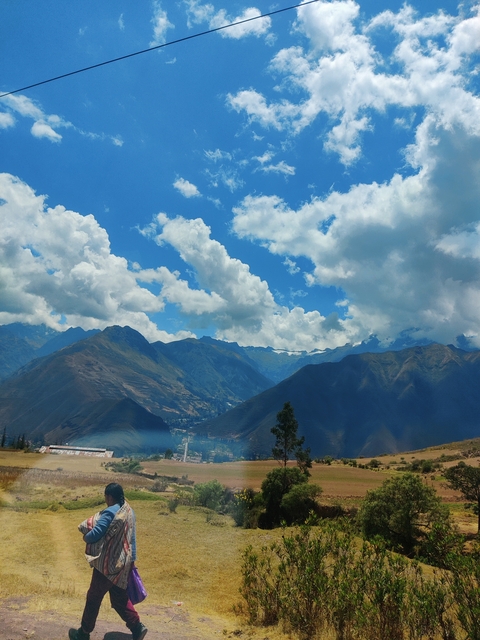       Mountain range with clear blue sky and clouds.
  