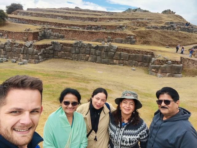       Group in front of ancient stone ruins.
  
