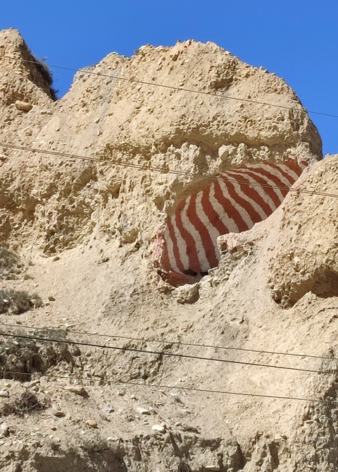       Red and white dome carved into the rock.
  