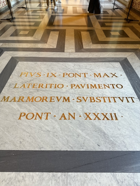       Marble inscription with golden text.
  